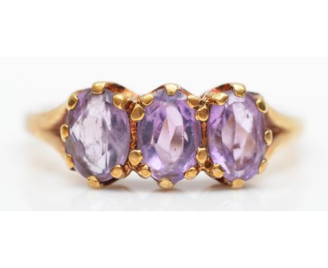 A 9ct rose gold Victorian style three stone amethyst ring, L, 2.5gm 