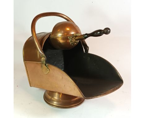 An early 20th century copper coal scuttle, together with a brass fire fender and a brass three fold fire screen. 