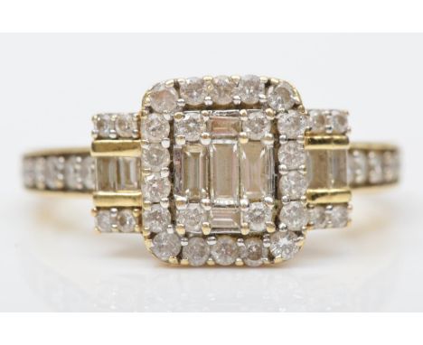 A 14ct gold baguette and brilliant cut diamond cluster ring, diamond set shoulders and shank, P 1/2, 4.9gm 