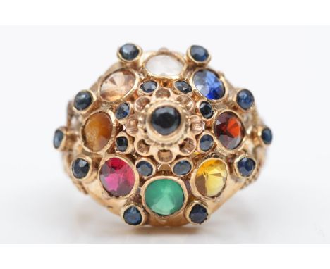 A multi gemset cluster ring, stamped 14K, including ruby, sapphire, and tigers eye, L 1/2, 5gm 