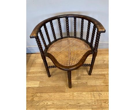 An early 20th century bobbin turned corner chair with cane seat.W57, H63cm. 