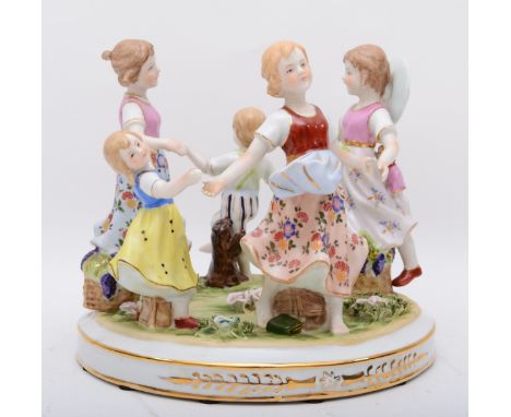 A Neundorf of Germany porcelain figural group `Ring a Ring a Roses`30cm diameter. 