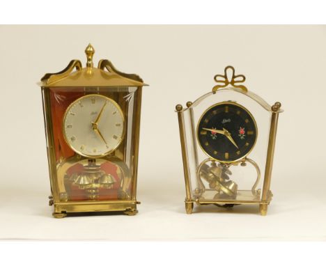 A Schatz German 400 day lantern clock, brass cased with bevel edge glass panel, 19cm tall, together with a smaller example. (