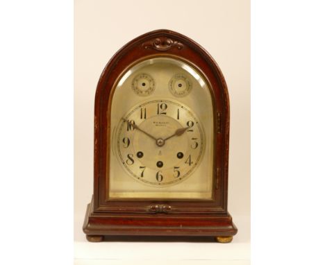 An early 20th century German Junghans mantel clock, mahogany case in archform, the silvered dial with arabic numerals speed &