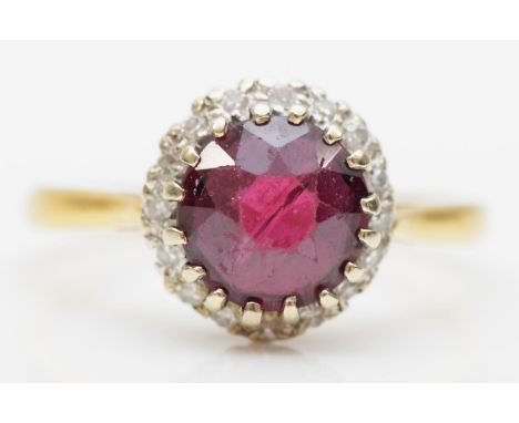 A vintage 18ct gold garnet and brilliant cut diamond cluster ring, stone 7mm, K, 3gm 