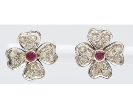A vintage pair of white gold ruby and brilliant cut diamond flower head cluster ear rings, tests 18ct gold, screw fittings, 1