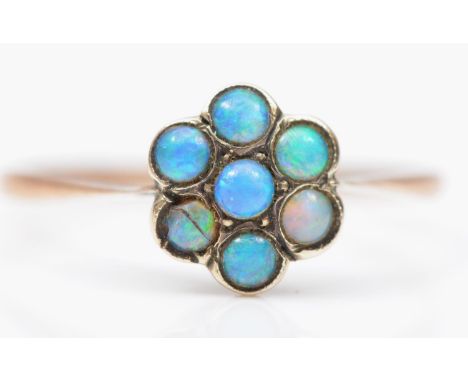 A vintage 9ct rose gold opal daisy cluster ring, one stone cracked, possible doublets, N 1/2, 1gm