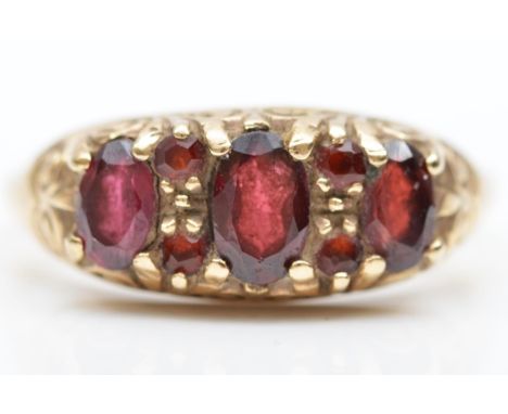 A 9ct gold Victorian style three stone garnet ring, garnet points between, Q 1/2, 3.4gm 