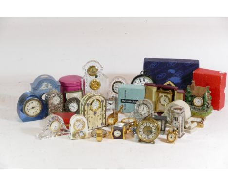 A collection of miniature novelty clocks, together with traveling alarm clocks, having manual wind and quartz movements. (2) 