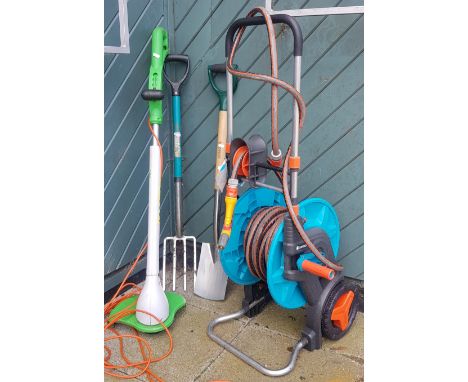 A Gardena hose trolley with hosepipe, together with a garden electric strimmer and stainless steel spade &amp; fork. 