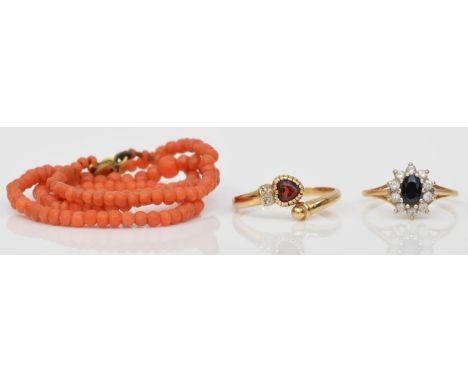 A 9ct gold and garnet heart ring, R, a 9ct gold sapphire and white stone ring, O, 3.8gm and a Victorian coral bead necklace 