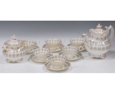 A Coalport part tea service, circa 1840, of neo-rococo form, with gilt lines over a grey checked ground, the teapot with drag