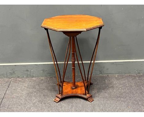 An Edwardian octagonal top mahogany occasional table, with central pole column and 8 stick supports on a concave platform bas