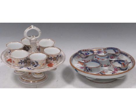 A Spode imari egg cup stand and four cups, with salt cellar, circa 1815; together with a Continental porcelain egg cup stand 