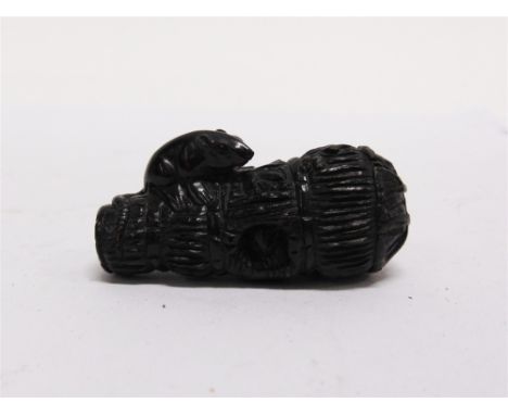 A CARVED HARDWOOD NETSUKE  modelled as a mouse on top of a corn bale, inset signature panel, 5.5cm long 