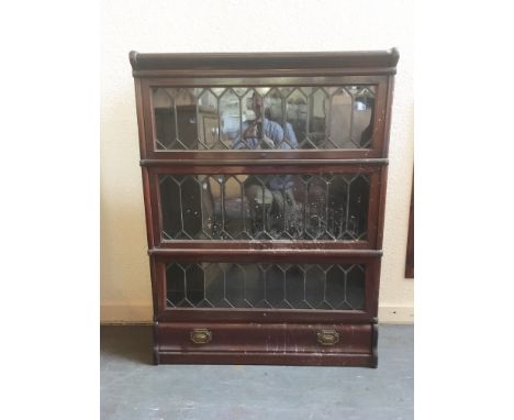 A THREE TIER MAHOGANY GLOBE WERNICKE BOOKCASE  with lead glazed doors and drawer to base, 86cm wide 27cm deep 115cm high