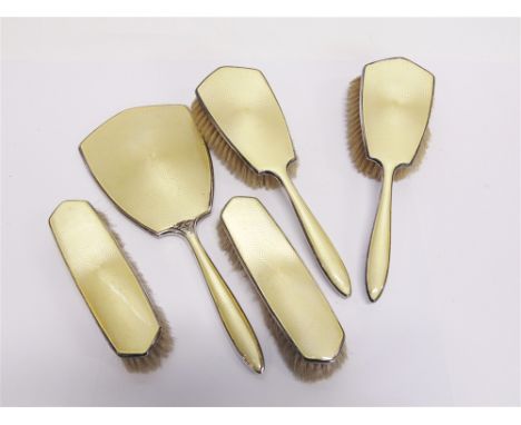 A FIVE PIECE GUILLOCHE ENAMEL AND SILVER DRESSING TABLE SET  comprising a hand mirror; two hair brushes; and two clothes brus