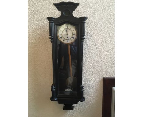 A REGULATOR STYLE WALL CLOCK   the enamel dial with subsidiary seconds dial, single weight, in ebonised case 36cm wide 106cm 