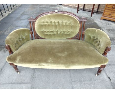 A VICTORIAN CARVED MAHOGANY FRAMED SOFA  with button upholstered back, 150cm wide 77cm deep 90cm high