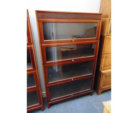 A FOUR SECTION MAHOGANY GLOBE WERNICKE STYLE BOOKCASE  with blind fret carved frieze, 87cm wide 25cm deep 146cm high (matchin