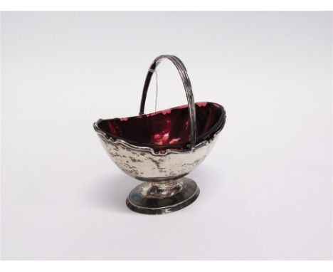 AN EDWARDIAN SILVER SWING HANDLED SUGAR BASKET by H. Atkin, Sheffield 1905, of plain oval pedestal form with a shaped rim, ru