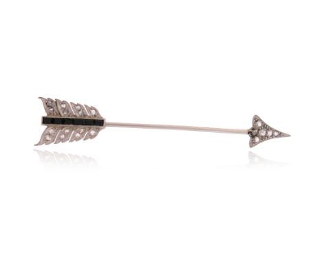 An early 20th century gem-set jabot pin, designed as an arrow, set with rose-cut diamonds and calibré-cut onyx in platinum on