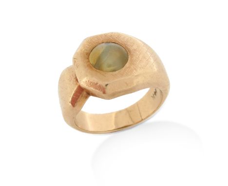 A chrysoberyl catseye and gold ring, the cabochon chrysoberyl set in textured yellow gold mount, size O
Condition report:&nbs