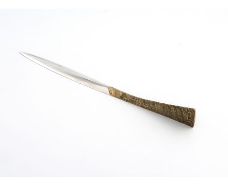 By Stuart Devlin, a modern parcel-gilt silver letter opener, London 1973, tapering form, raised tail-fin handle with textured