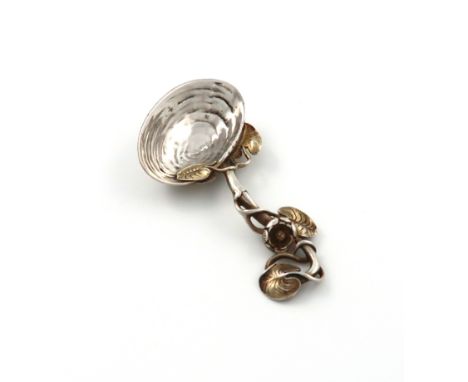 A Victorian parcel-gilt cast silver caddy spoon, by Francis Higgins, London 1890, shell bowl, with a lily pad handle with gil