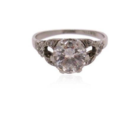 A diamond solitaire ring, the round brilliant-cut diamond weighs approximately 1.20cts, with diamond shoulders in platinum, s