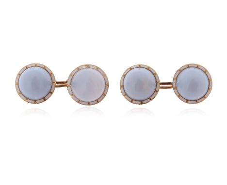 A pair of chalcedony and enamel gold cufflinks, the blue chalcedony cabochons set within a surround of white enamel in yellow
