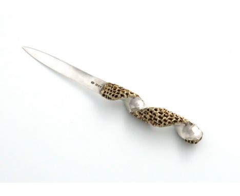 By Stuart Devlin, a modern parcel-gilt silver letter opener, London 1980, tapering form, with a pierced and textured swirl ha