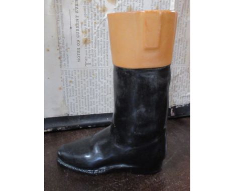 A china stirrup cup, formed as a hunting boot