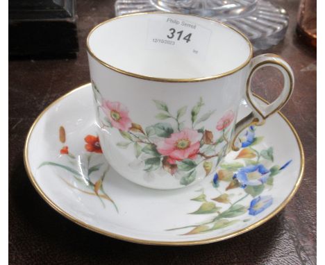 A Royal Worcester cup and saucer decorated with flowers&nbsp;
