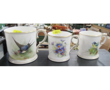 Three Royal Worcester mugs, with hand painted decoration, one of flowers signed Everett, one of a Blue Tit signed Everett and