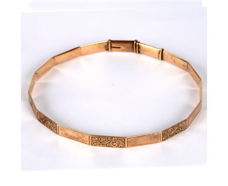 A 9ct gold arm bangle, of polygonal shape with alternate plain and engraved panels, approximately 21.7gm CONDITION REPORT: It