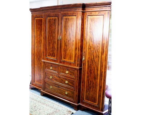 A Victorian mahogany and satinwood crossbanded breakfront wardrobe, the central section with press cupboard over two short an