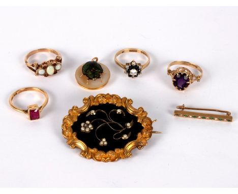 An early Victorian mourning brooch the floral motif set pearls and a small diamond to a black enamel ground within a scrollin