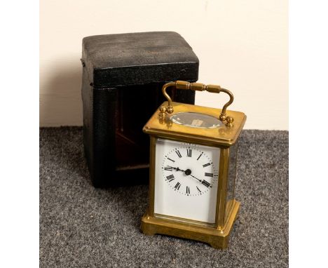 A gilt brass cased carriage clock, the white enamel dial with Roman numerals, in original carry case