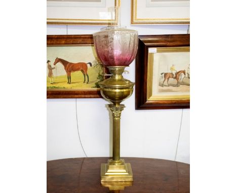 A Victorian oil lamp with brass column and glass shade CONDITION REPORT: Well and square base have slight dents and other min