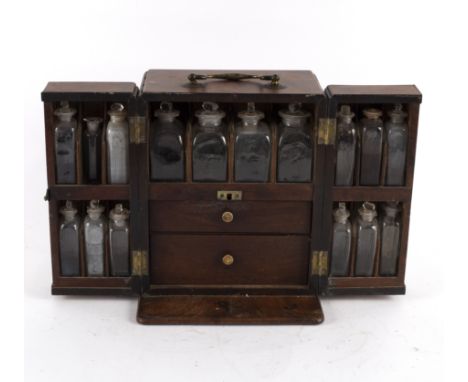 A 19th Century apothecary box, the hinged doors concealing compartments containing medicine bottles, weighing scales and a pe