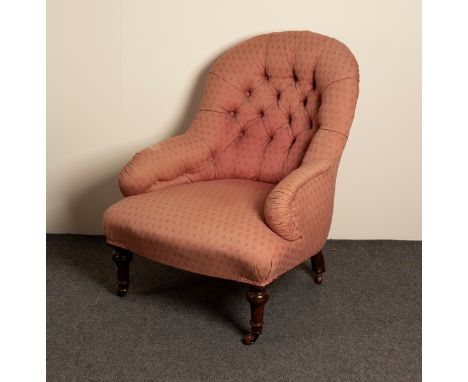 A Victorian button back chair on turned legs