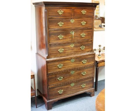 A George III mahogany chest on chest, the upper section with dentil cornice over two short and three long drawers, the base f