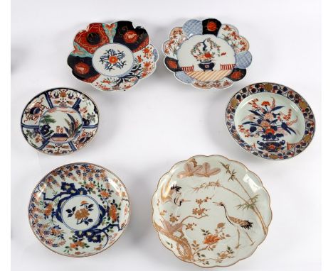 Three Japanese Imari circular dishes, 18th Century, painted with flowers and one with a pair of figures, together with two Ja