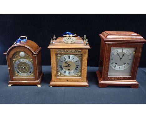 A MAHOGANY CASED ELLIOTT CLOCK with a similar in walnut by Thwaites and Reed and another, the largest 28cm high (3)
