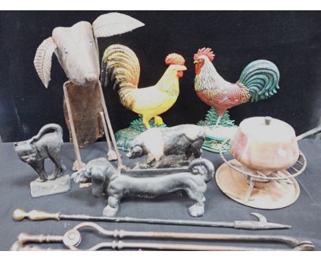 A COLLECTION OF CAST IRON DOORSTOPS a Dachshund boot scraper, steel fire tools, a nodding dog garden ornament, and a fondue p