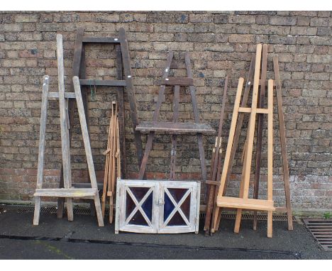 A GROUP OF SEVEN VINTAGE ARTISTS EASELS the tallest when closed 175cm high, some requiring restoration, and a small casement 