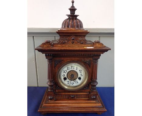 A VICTORIAN WALNUT CASED MANTEL CLOCK striking on a gong, the architectural styled case with domed top, Wurttemberg manufactu