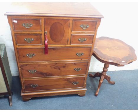 A SMALL YEW VENEERED CHEST OF DRAWERS George III style, with four small drawers flanking a central door, with three drawers u