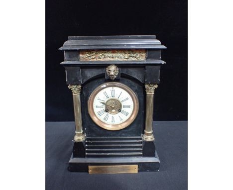 A VICTORIAN SLATE-CASED MANTEL CLOCK striking on a gong, with pillared case, with plaque, presented in 1886. 40cm high (a/f)